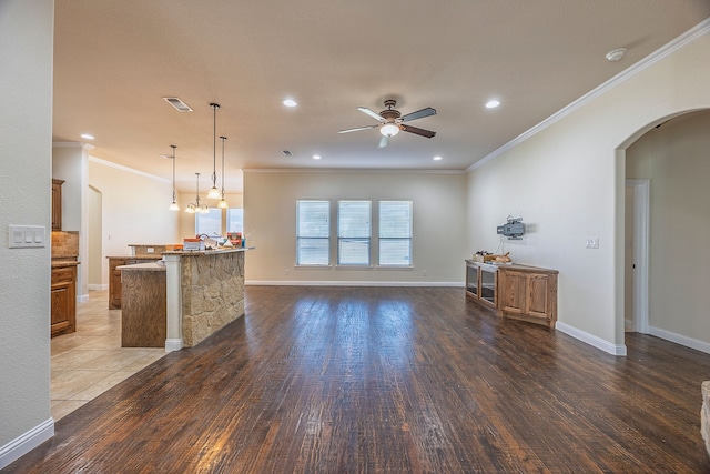 living room featuring dark hardwood / wood-style floors, ceiling fan, and ornamental molding