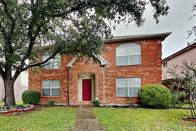 view of property featuring a front lawn