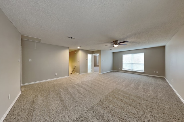 unfurnished room with light carpet, a textured ceiling, and ceiling fan