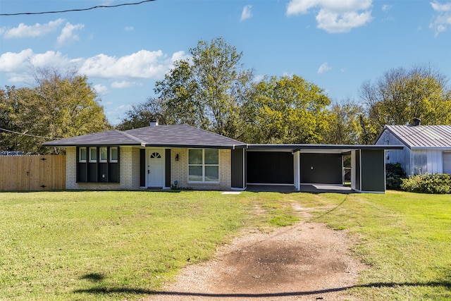 ranch-style home with a front yard and a carport