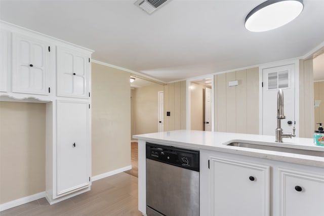 kitchen featuring stainless steel dishwasher, ornamental molding, sink, light hardwood / wood-style flooring, and white cabinets