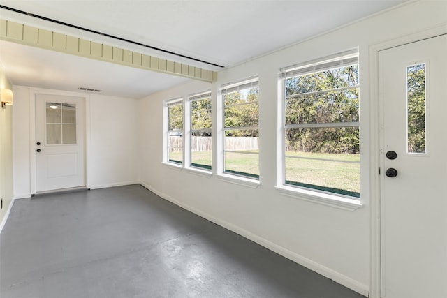 unfurnished sunroom with a wealth of natural light