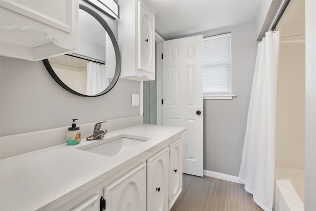 bathroom featuring tile patterned floors, vanity, and shower / tub combo with curtain