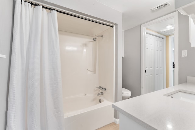 full bathroom featuring vanity, shower / bath combo, and toilet