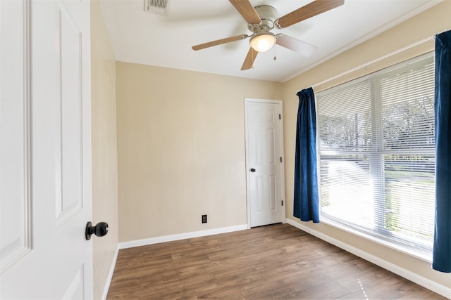 empty room with ceiling fan and wood-type flooring