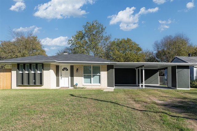 view of front of house with a front lawn and a carport