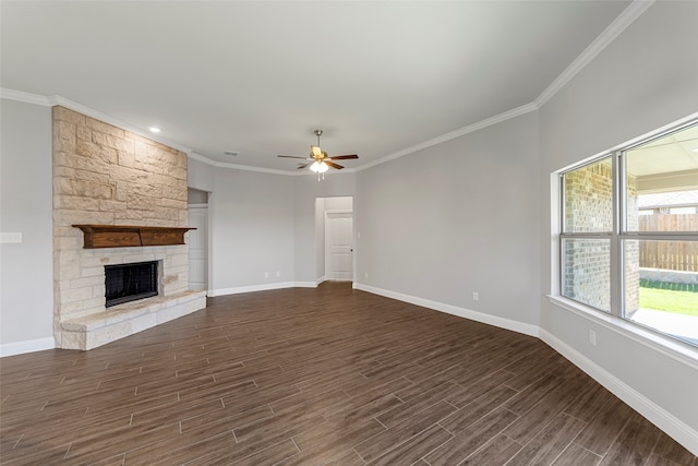 unfurnished living room with ornamental molding, a stone fireplace, dark wood-type flooring, and ceiling fan