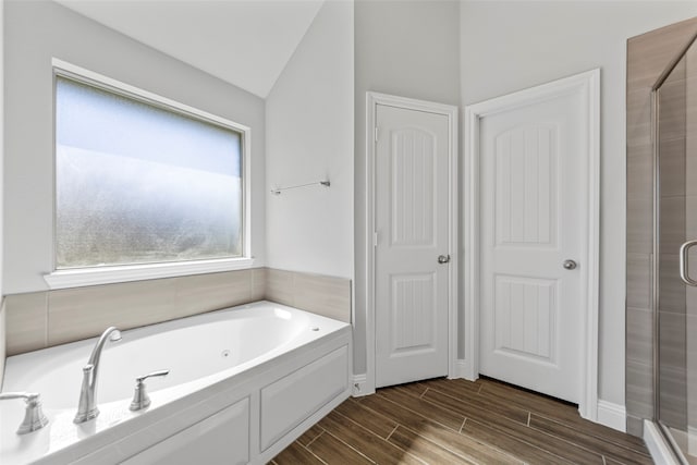 bathroom with lofted ceiling and plus walk in shower