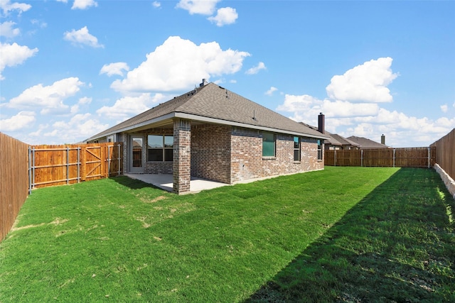 back of house featuring a patio and a lawn