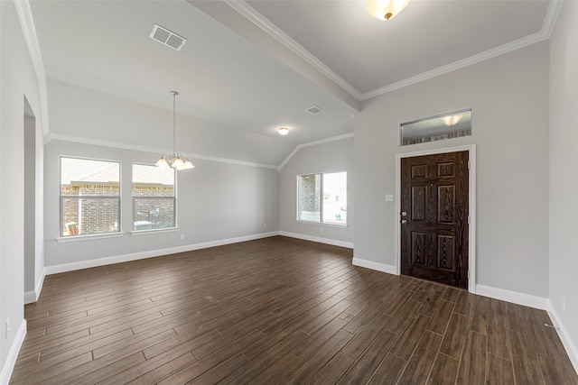 foyer entrance featuring lofted ceiling, a notable chandelier, crown molding, and dark hardwood / wood-style floors