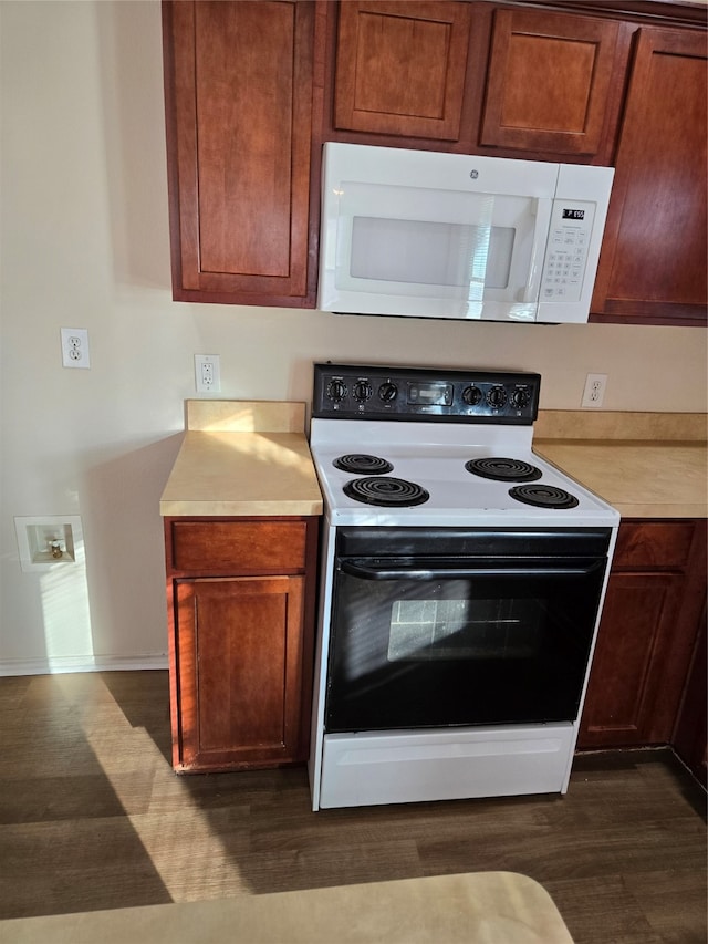 kitchen with dark wood-type flooring and white appliances