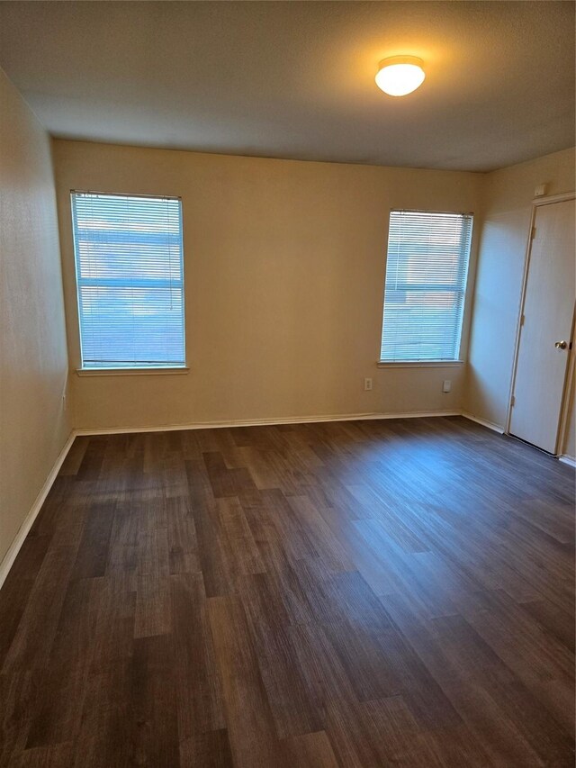 empty room featuring dark hardwood / wood-style floors