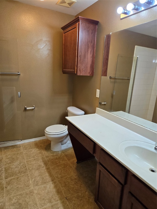 bathroom with tile patterned flooring, toilet, an enclosed shower, and vanity