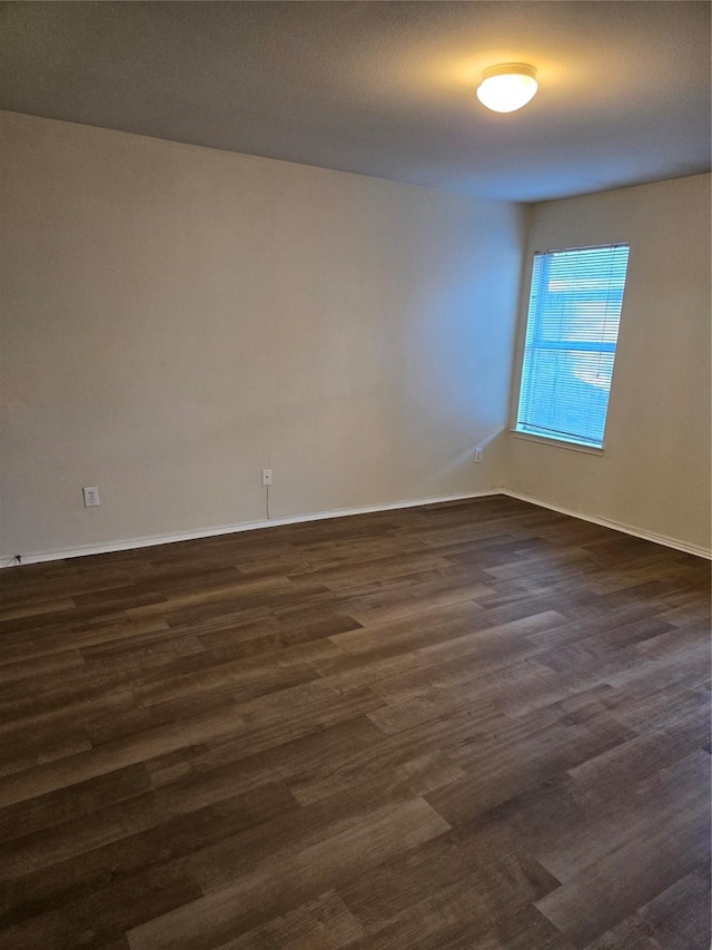 spare room featuring dark hardwood / wood-style flooring