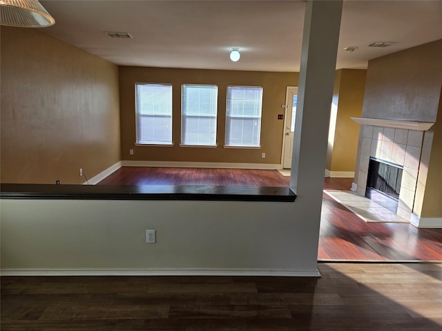 kitchen with hardwood / wood-style flooring and a fireplace