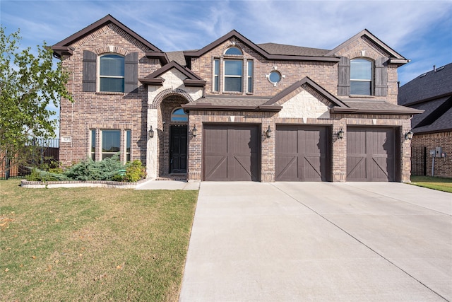 view of front facade with a garage and a front lawn