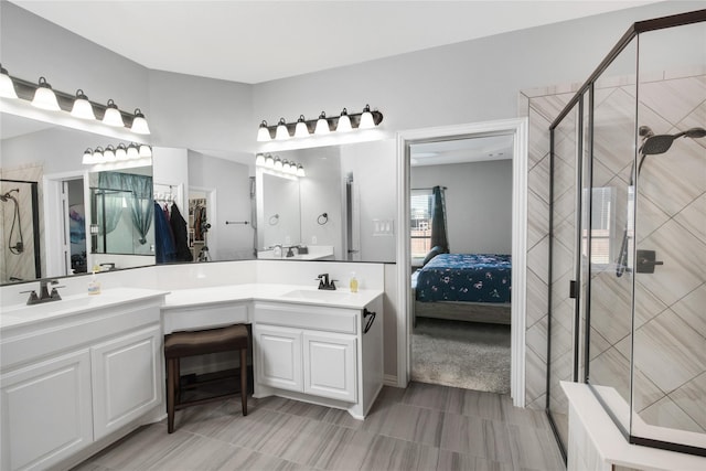 bathroom featuring vanity and a shower with shower door