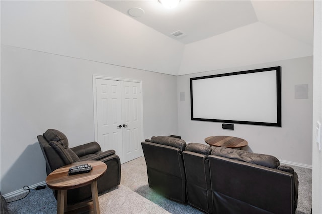 carpeted cinema room with lofted ceiling