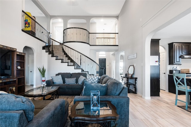 tiled living room with a towering ceiling