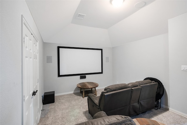 home theater featuring light colored carpet and lofted ceiling