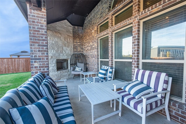 view of patio with an outdoor living space with a fireplace