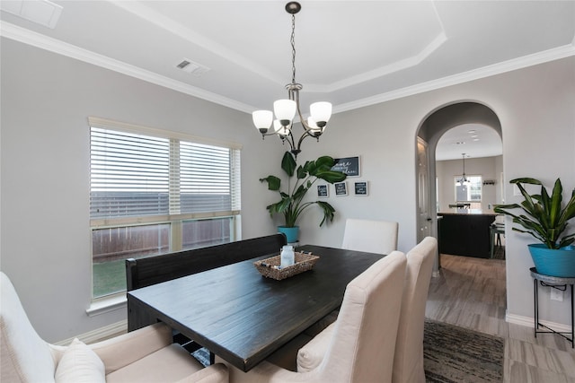 dining space featuring an inviting chandelier and ornamental molding