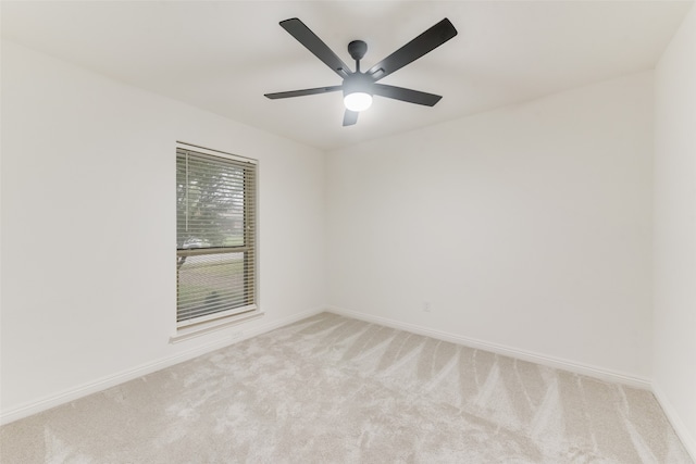 spare room with light colored carpet and ceiling fan