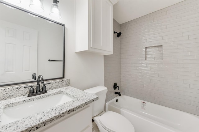 full bathroom featuring vanity, tiled shower / bath combo, and toilet