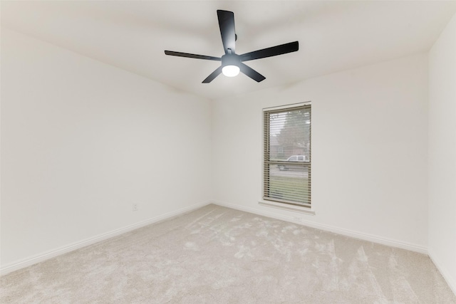 empty room with ceiling fan and light colored carpet