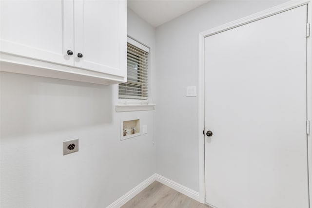 laundry room featuring cabinets, electric dryer hookup, washer hookup, and light wood-type flooring