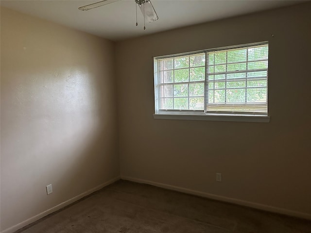 empty room featuring ceiling fan and carpet flooring