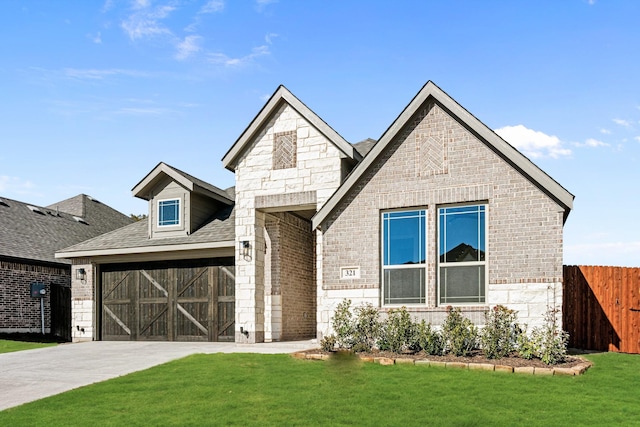 view of front of house with a front lawn and a garage