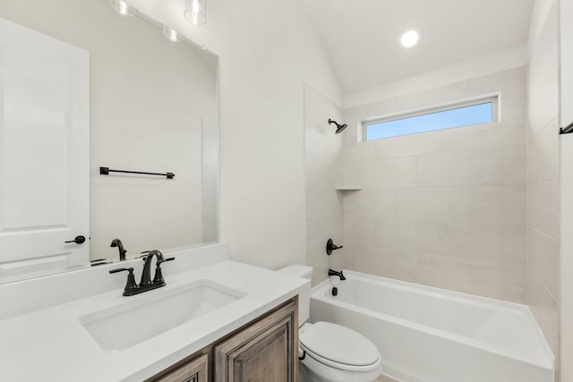 full bathroom with vanity, toilet, tiled shower / bath, and lofted ceiling