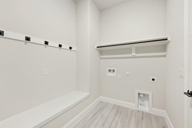 clothes washing area featuring washer hookup, light wood-type flooring, hookup for a gas dryer, and electric dryer hookup