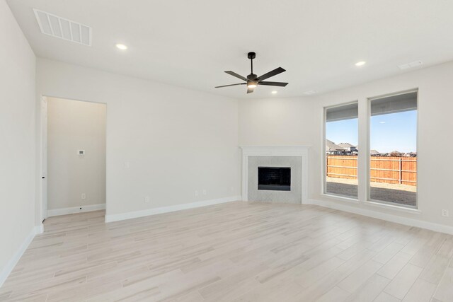 unfurnished living room with ceiling fan and light hardwood / wood-style floors