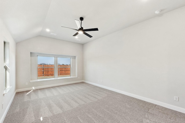 empty room with light carpet, ceiling fan, and vaulted ceiling