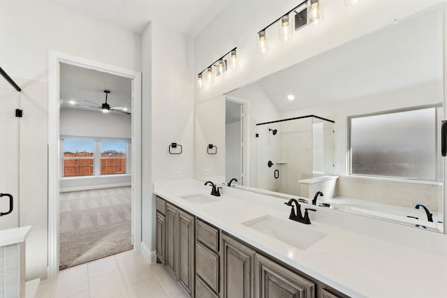 bathroom with tile patterned floors, ceiling fan, vanity, and separate shower and tub