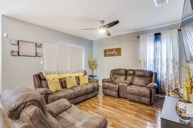 living room featuring light wood-type flooring and ceiling fan