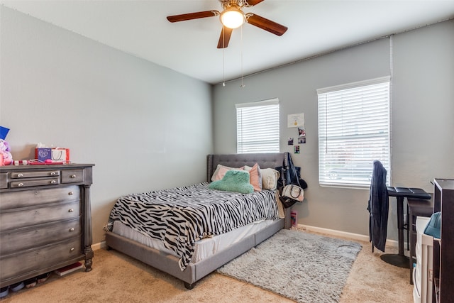 bedroom with light carpet and ceiling fan