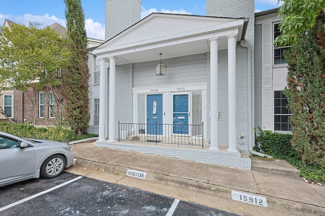 view of exterior entry featuring covered porch