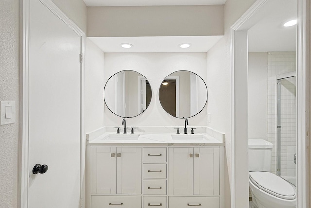 bathroom featuring an enclosed shower, vanity, and toilet