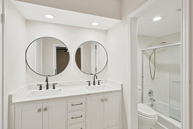 full bathroom with vanity, toilet, and bath / shower combo with glass door