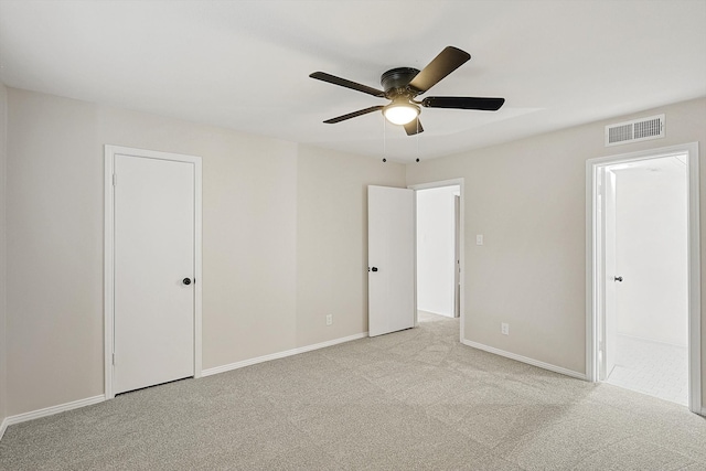 empty room with ceiling fan and light colored carpet