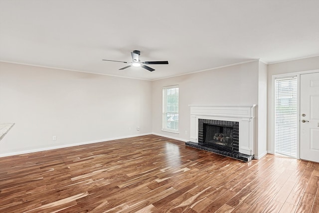 unfurnished living room with hardwood / wood-style flooring, plenty of natural light, ceiling fan, and crown molding