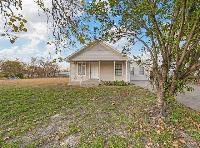 bungalow-style home featuring a porch and a front yard