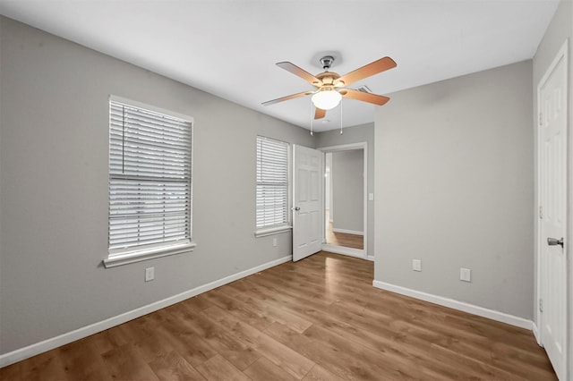 unfurnished bedroom with ceiling fan and hardwood / wood-style floors