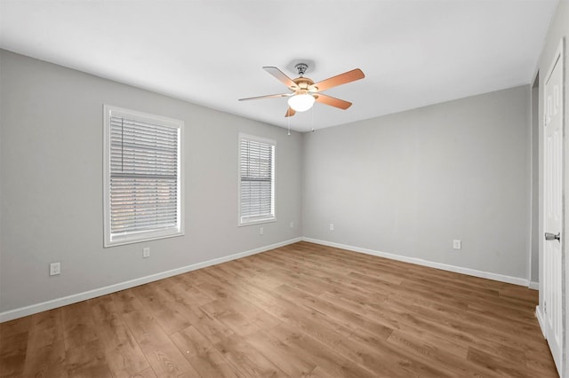 spare room with ceiling fan and wood-type flooring