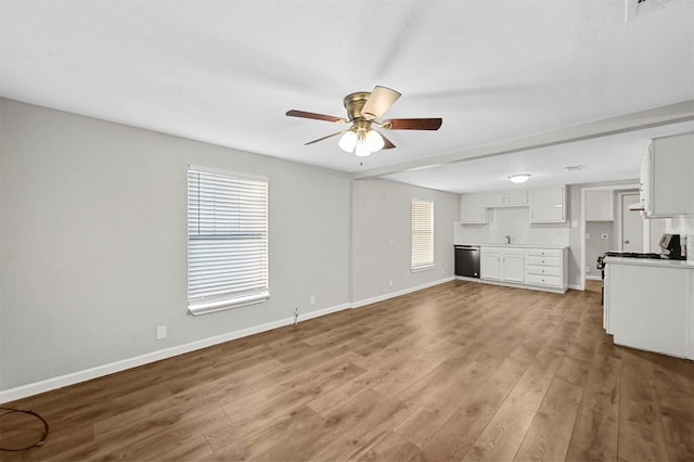 unfurnished living room featuring light wood-type flooring and ceiling fan