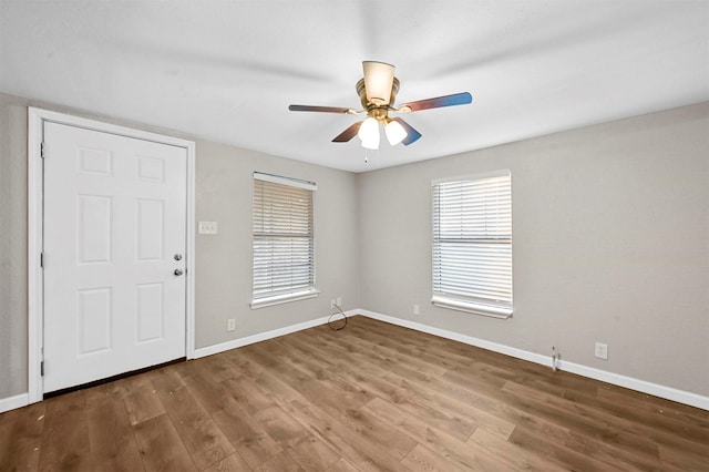 unfurnished room with ceiling fan and wood-type flooring