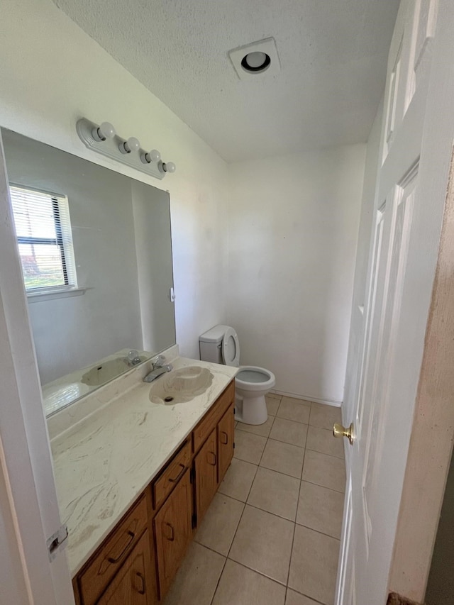 bathroom featuring tile patterned floors, vanity, and toilet